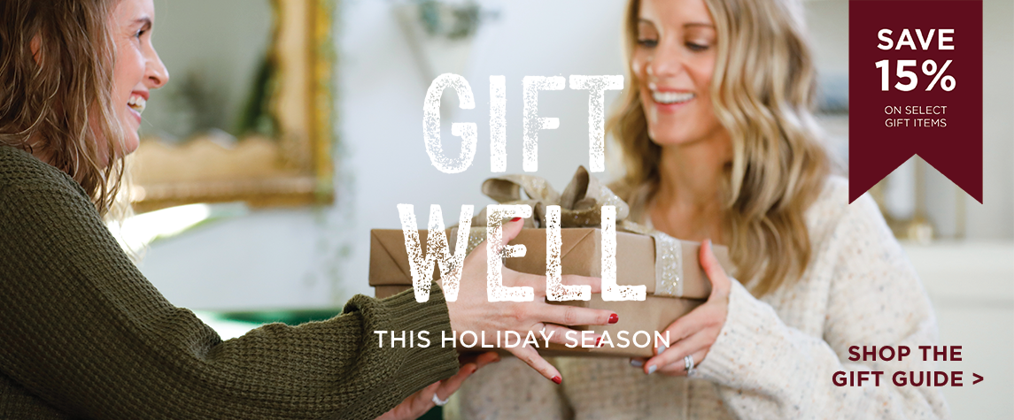 Friend giving another friend a wrapped gift with text GIFT WELL