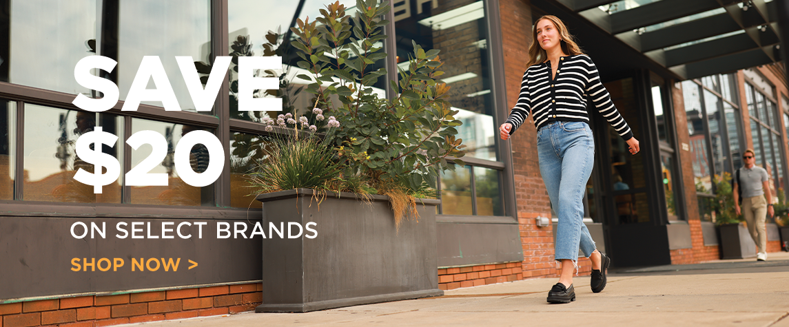 Woman walking down sidewalk wearing chunky loafers with text "Save $20. Shop now"