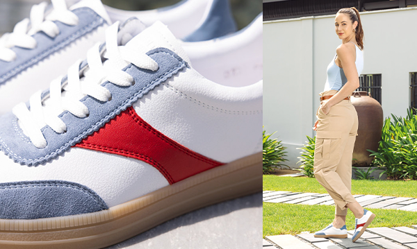 Woman walking outside wearing Remonte red white and blue retro sneakers