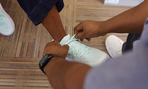Person getting their running shoes fit in person at Schuler Shoes store