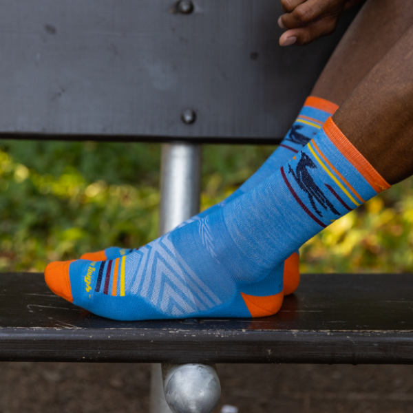 Man resting feet on bench