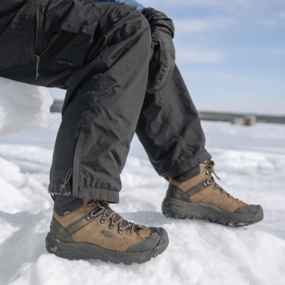 Man sitting in chair ice fishing