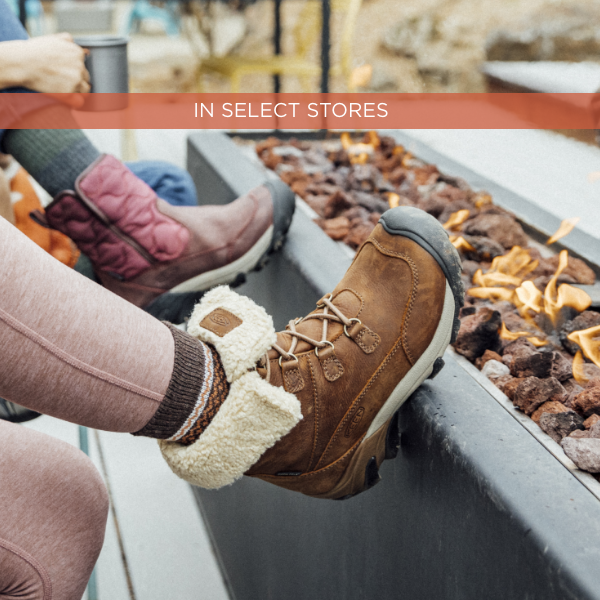 Woman resting foot on ledge of outdoor fireplace