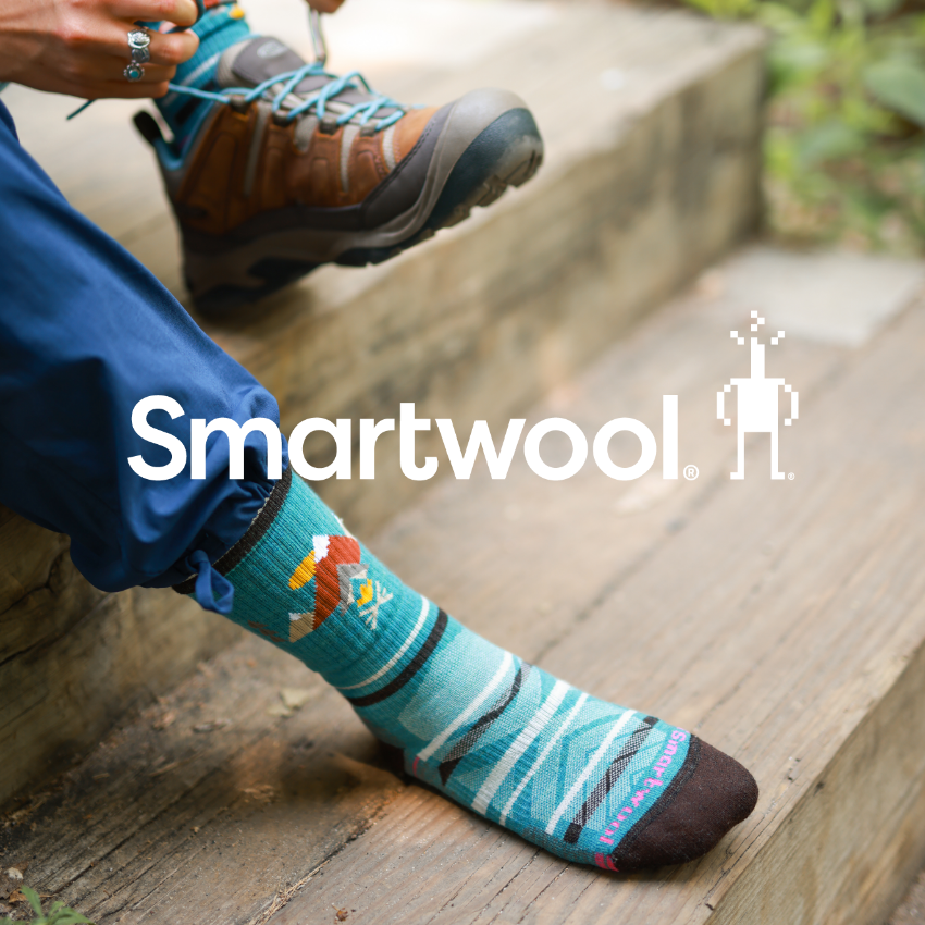 Woman sitting on outdoor steps putting on socks