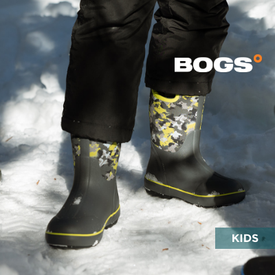 Kid standing in snow wearing Bogs boots
