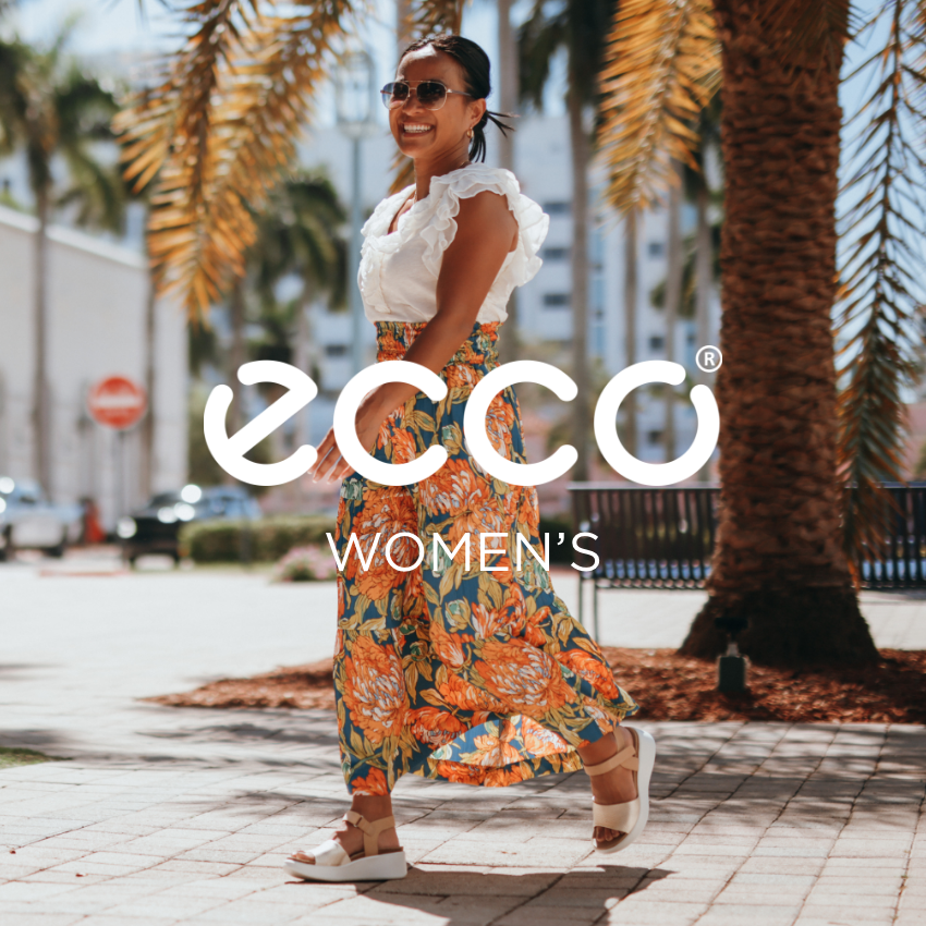 Woman walking through outdoor shopping mall