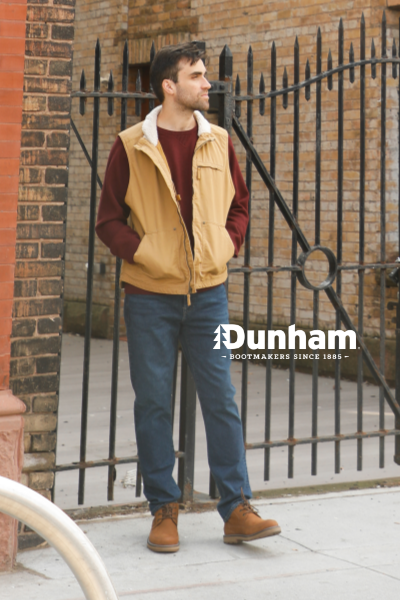 Man standing on sidewalk wearing Dunham boots