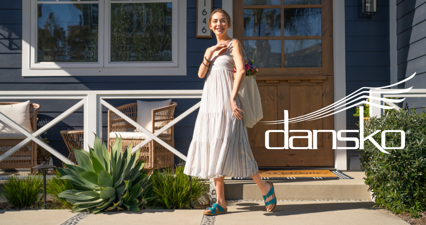 Woman walking in front of house