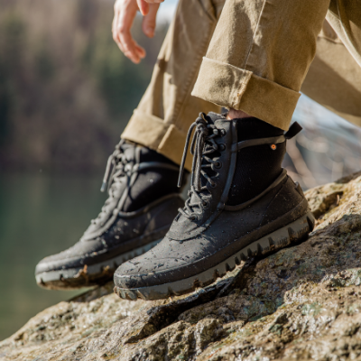 Man resting feet on rocks