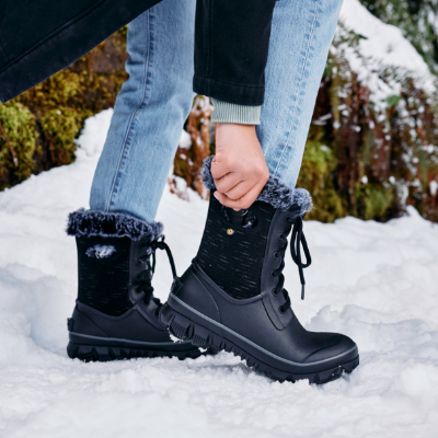 Woman pulling boot on 