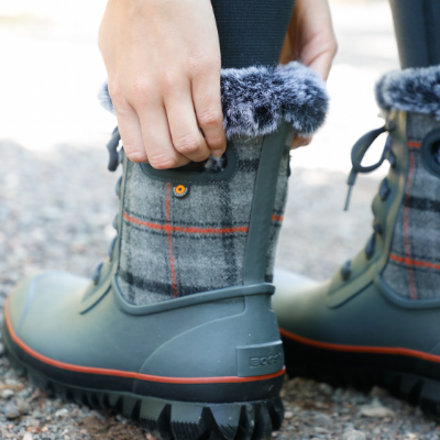 Woman pulling boot on