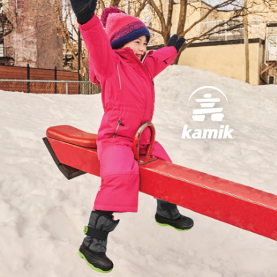 Kid playing on seesaw in snow wearing Kamik boots