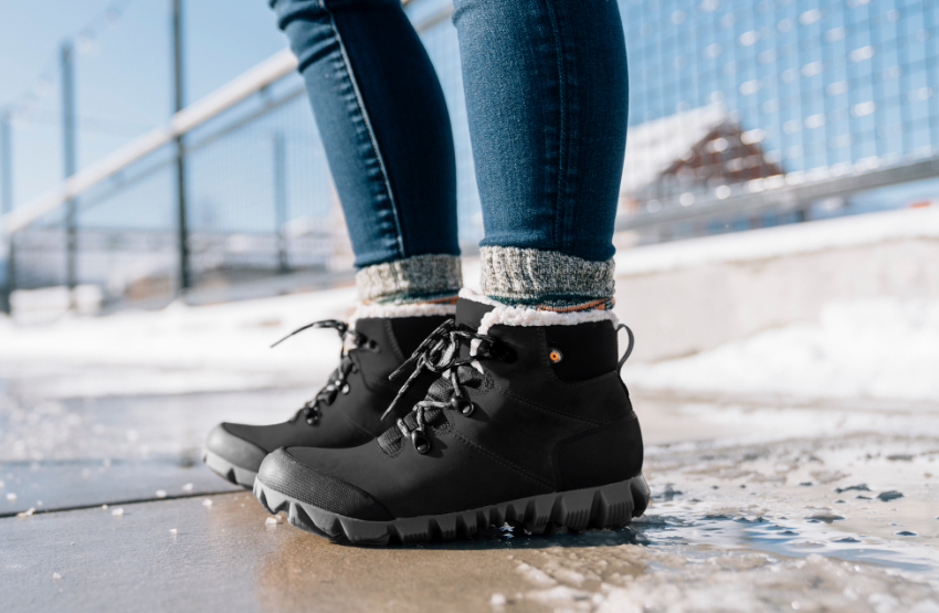 Woman standing on snowy sidewalk