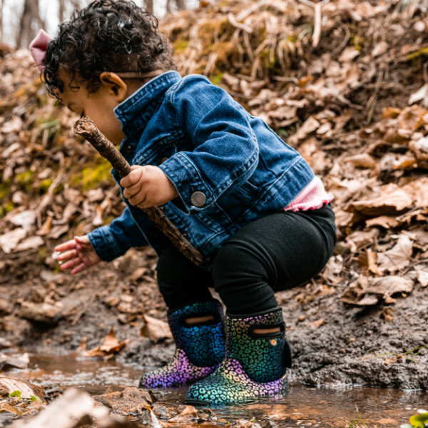 Little kid playing in the woods