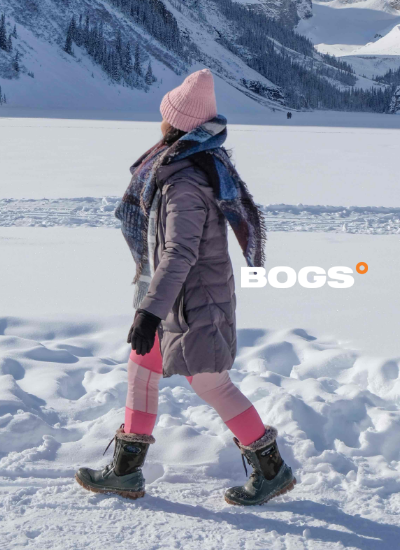 Woman walking on snowy path in Bogs boots