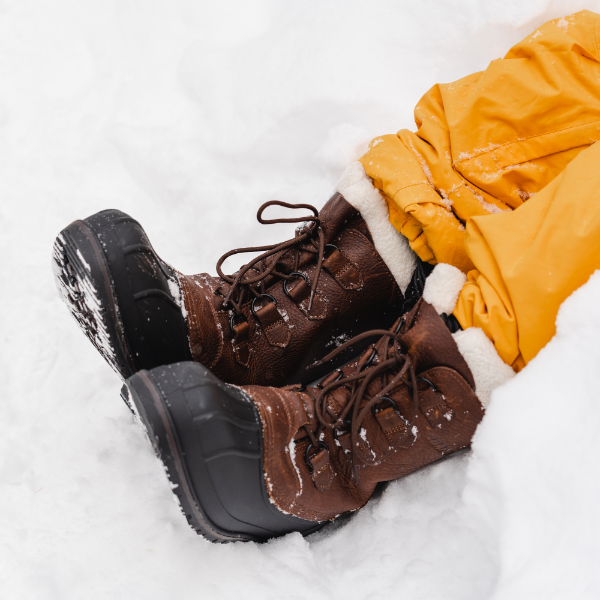 Man resting feet in snow