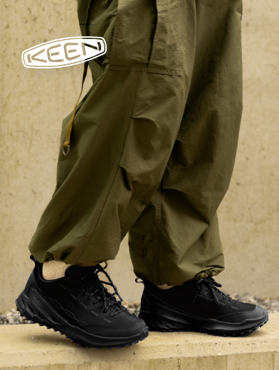 Man standing on sidewalk wearing Keen Jasper Zionic sneaker
