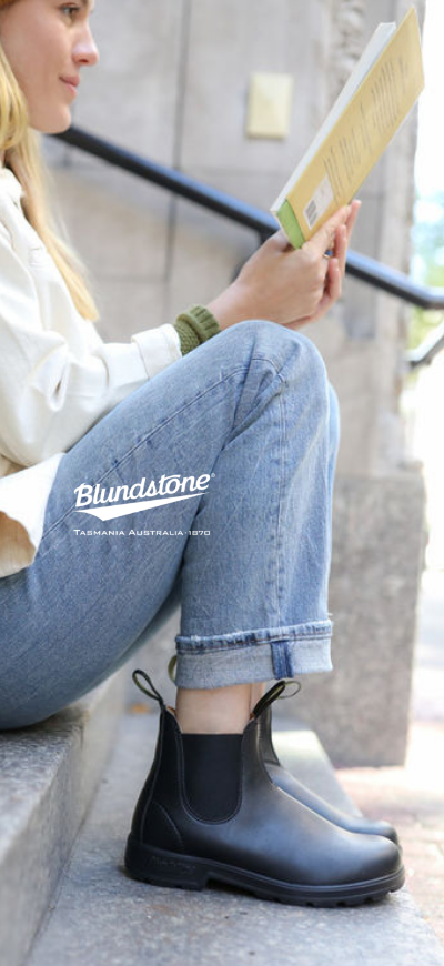 Woman sitting on outside steps in Blundstone Classic 550 boots
