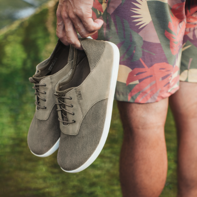 Man holding shoes in hand