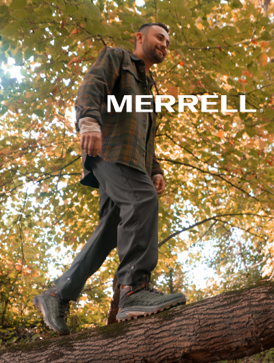 Man walking on dead tree wearing Merrell Moab Speed 2 Mid hiking boot