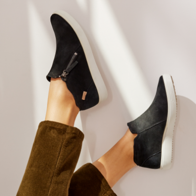 Woman posing feet on wall