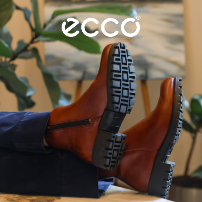 Woman sitting at desk with feet kicked up in Ecco Modtray Ankle boots