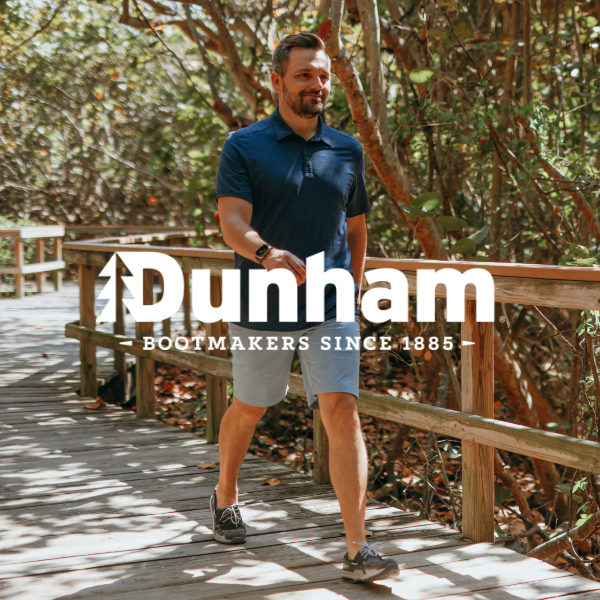 Man walking on wooden bridge pathway