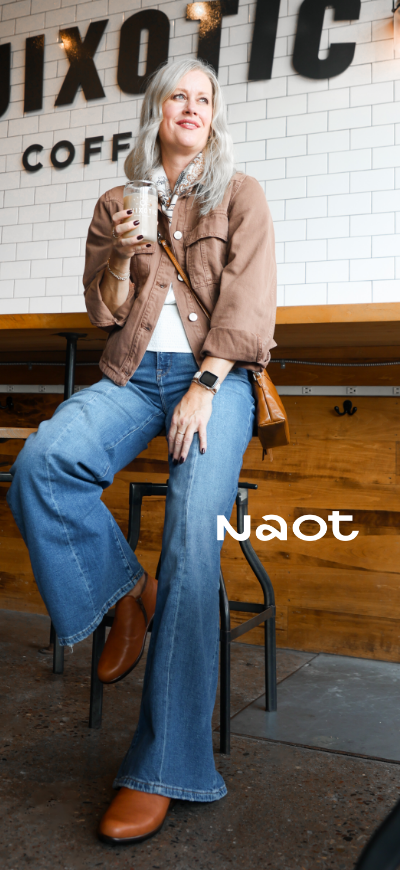 Woman sitting on barstool in coffee shop in Naot Helm boots
