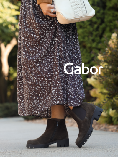 Woman standing on sidewalk posing in Gabor Poppy 710 boots