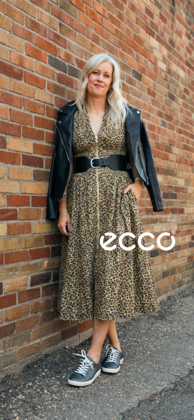 Woman leaning against brick wall in Ecco Soft 7 Sneakers