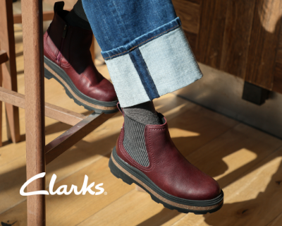 Woman sitting at high top chair wearing Clarks Hencroft boots