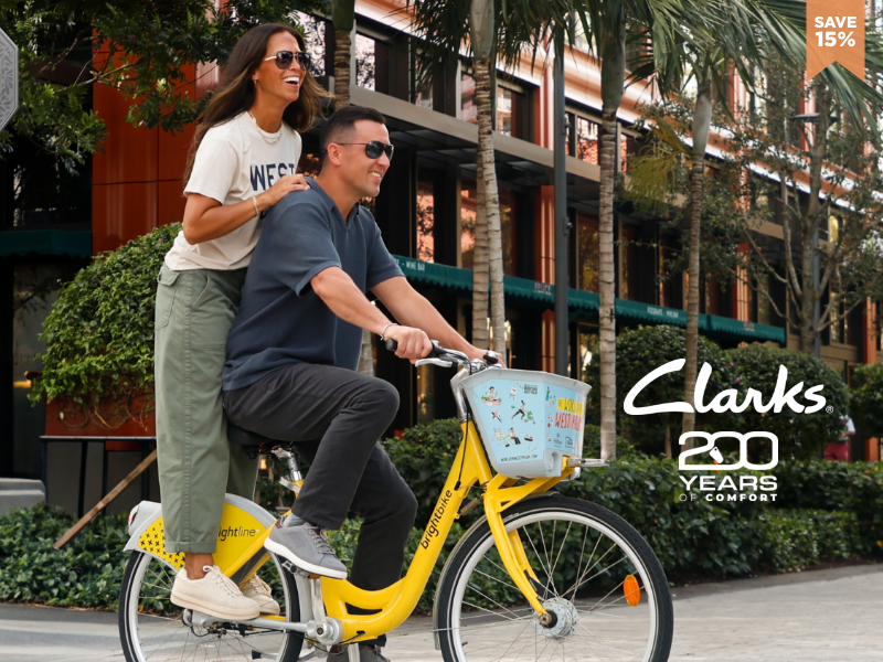 man and woman riding city bike in Clarks shoes