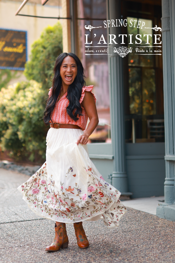 Woman twirling skirt on sidewalk