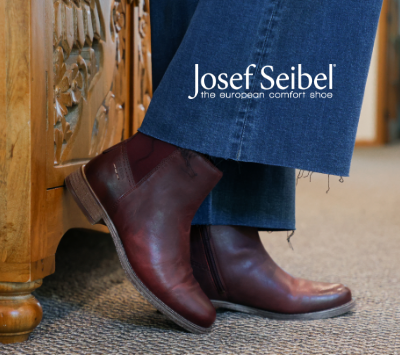 Woman leaning feet against office table in Josef Seibel Sienna 08 boots