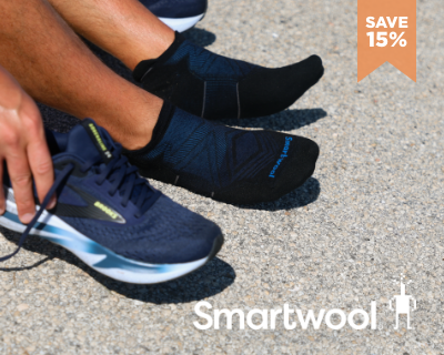 Man putting on Smartwool run socks
