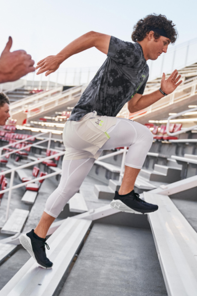 Man running up bleechers working out