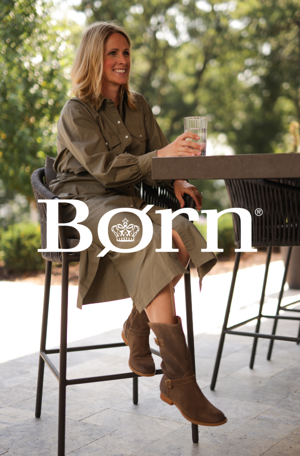 Woman sitting on stool at outdoor bar