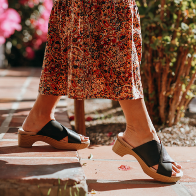Woman walking down sidewalk
