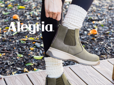 Woman pulling Alegria Frankie boot on 