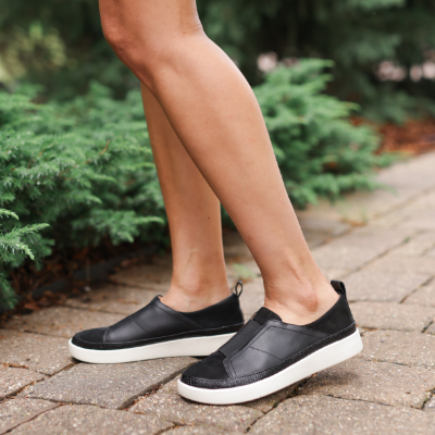 Woman standing on sidewalk