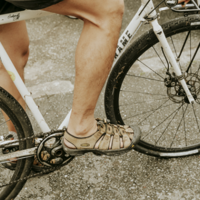 Man resting foot on bike pedal