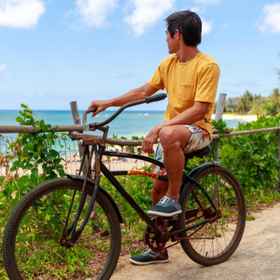 Man looking out at beach on bike