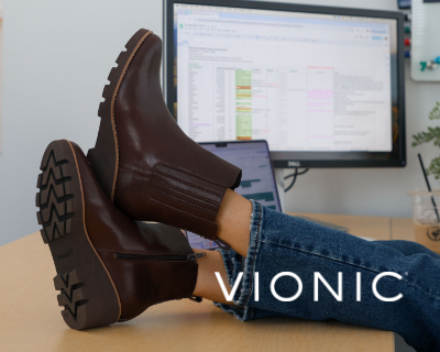 Woman sitting with feet up at desk in Vionic Aria boots
