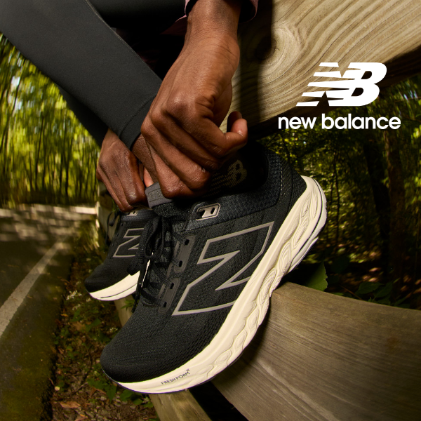 Man adjusting New Balance running shoe