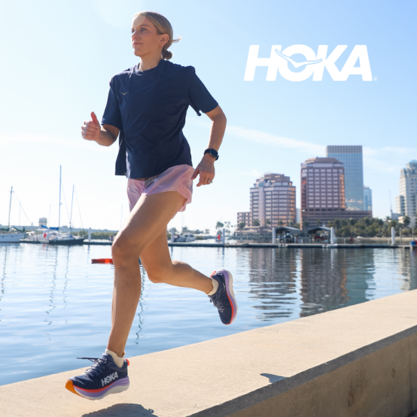 Woman running by water in Hoka Gaviota 5's