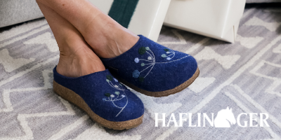 Woman sitting in chair wearing Haflinger Grizzly Amaya slippers
