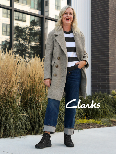 Woman standing on sidewalk posing in Clarks Carleigh Jade boots