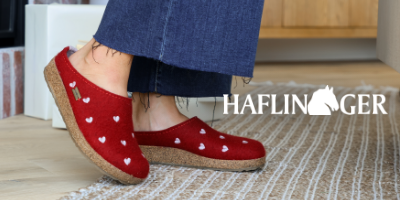 Woman standing by fireplace wearing Haflinger slippers