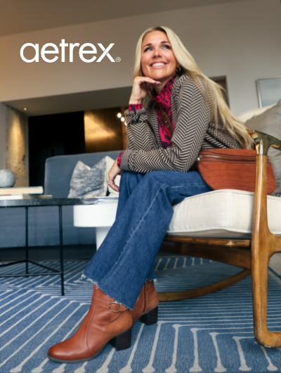 Woman sitting in chair with Aetrex Rebecca boots on 