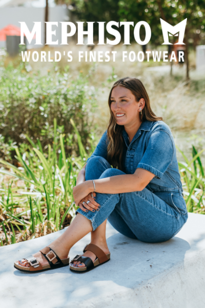Woman sitting on concrete bench hugging knees